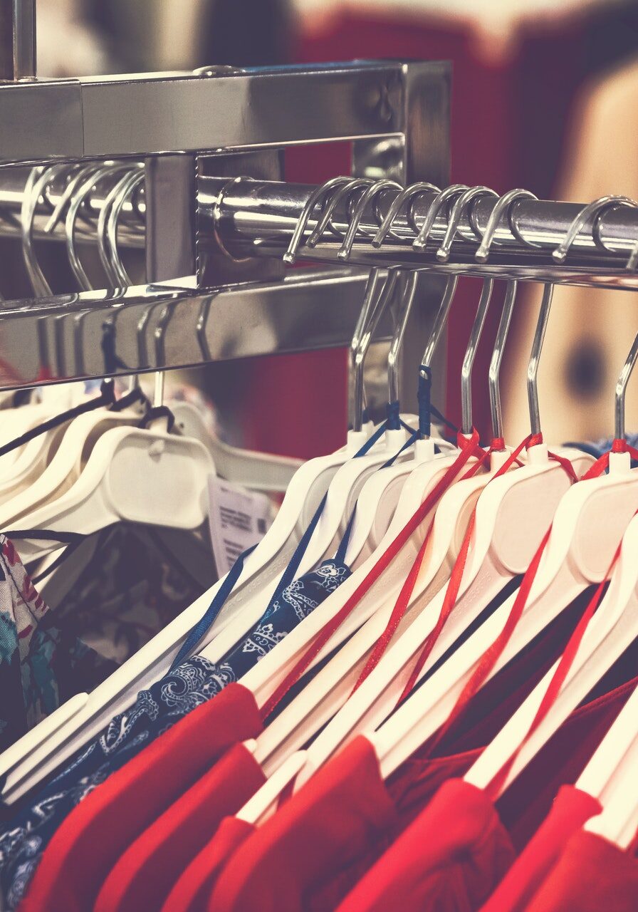 assorted-clothes-with-hangers-on-display-rack-2490920